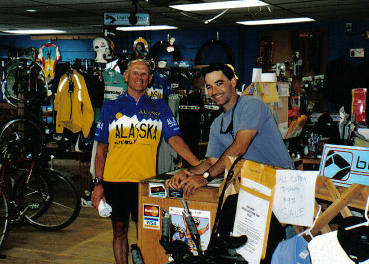 Tom in an Alaska cycling jersey at a bicycle shop