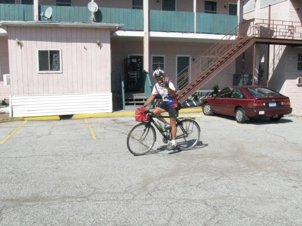 Tom waving from his bicycle in West Virginia