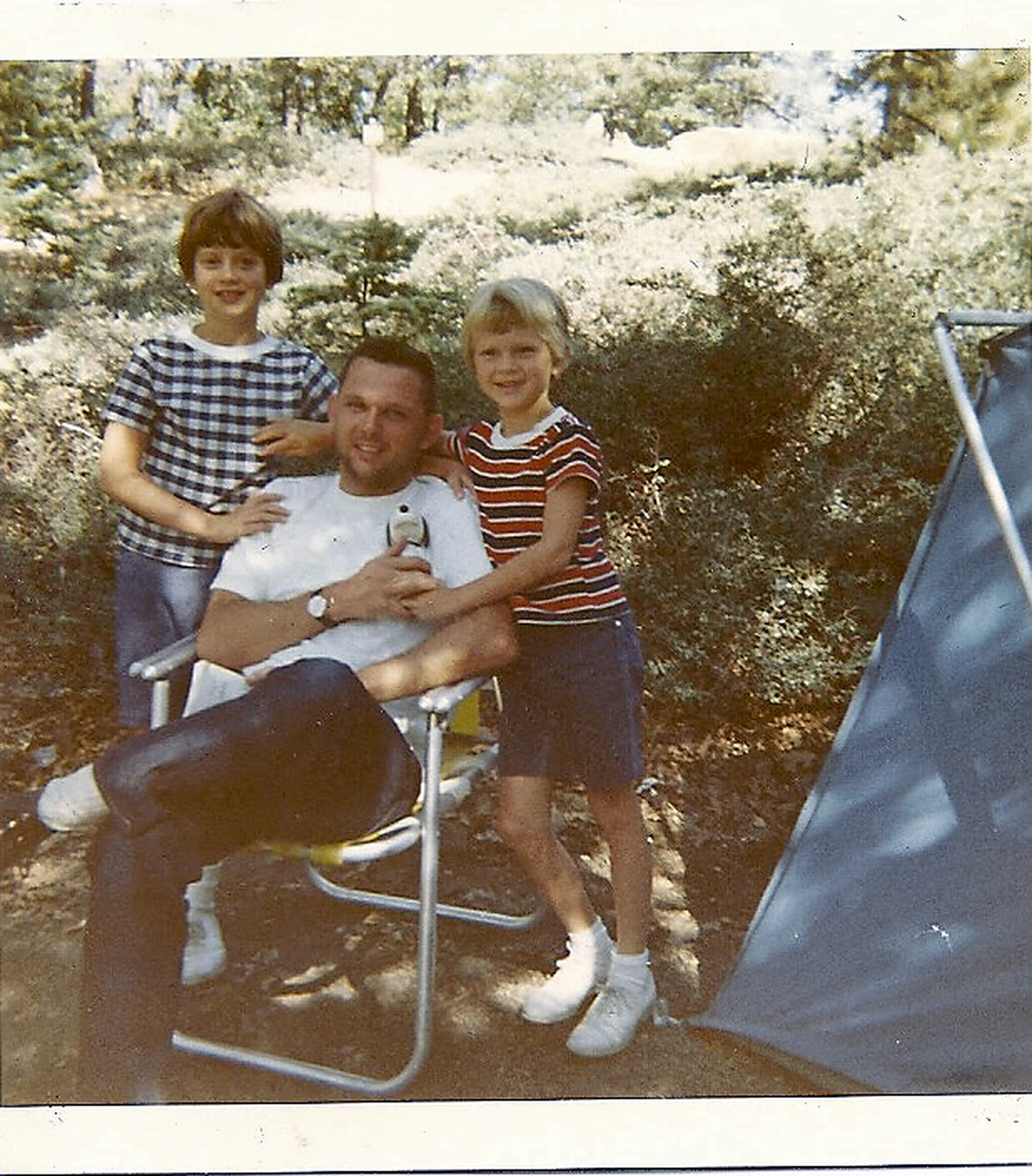Tom with his children during a camping trip.