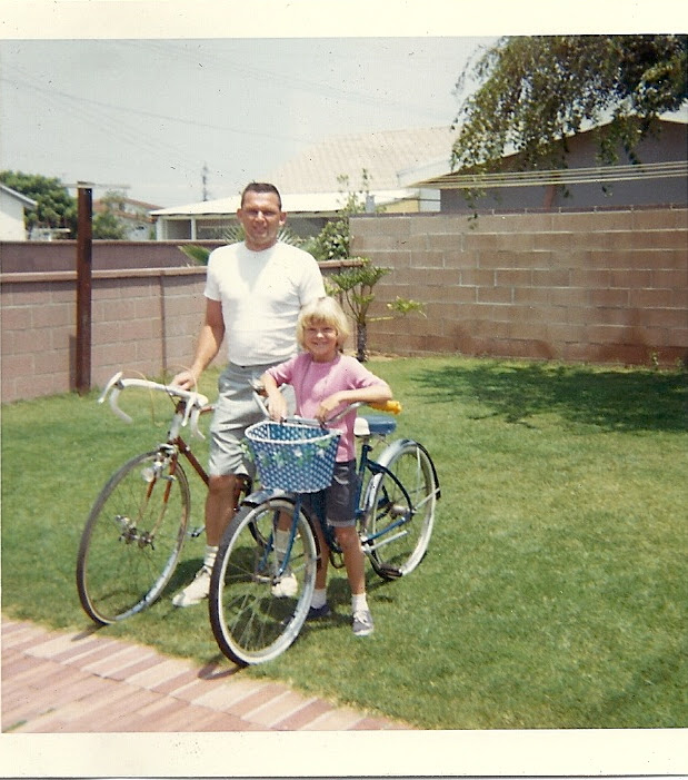 Tom sharing the bicycle with one of his children.