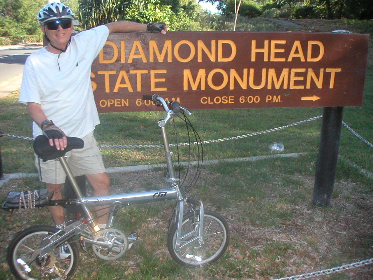 Tom or his touring bicycle photographed at the Hawaii state line or state landmark.