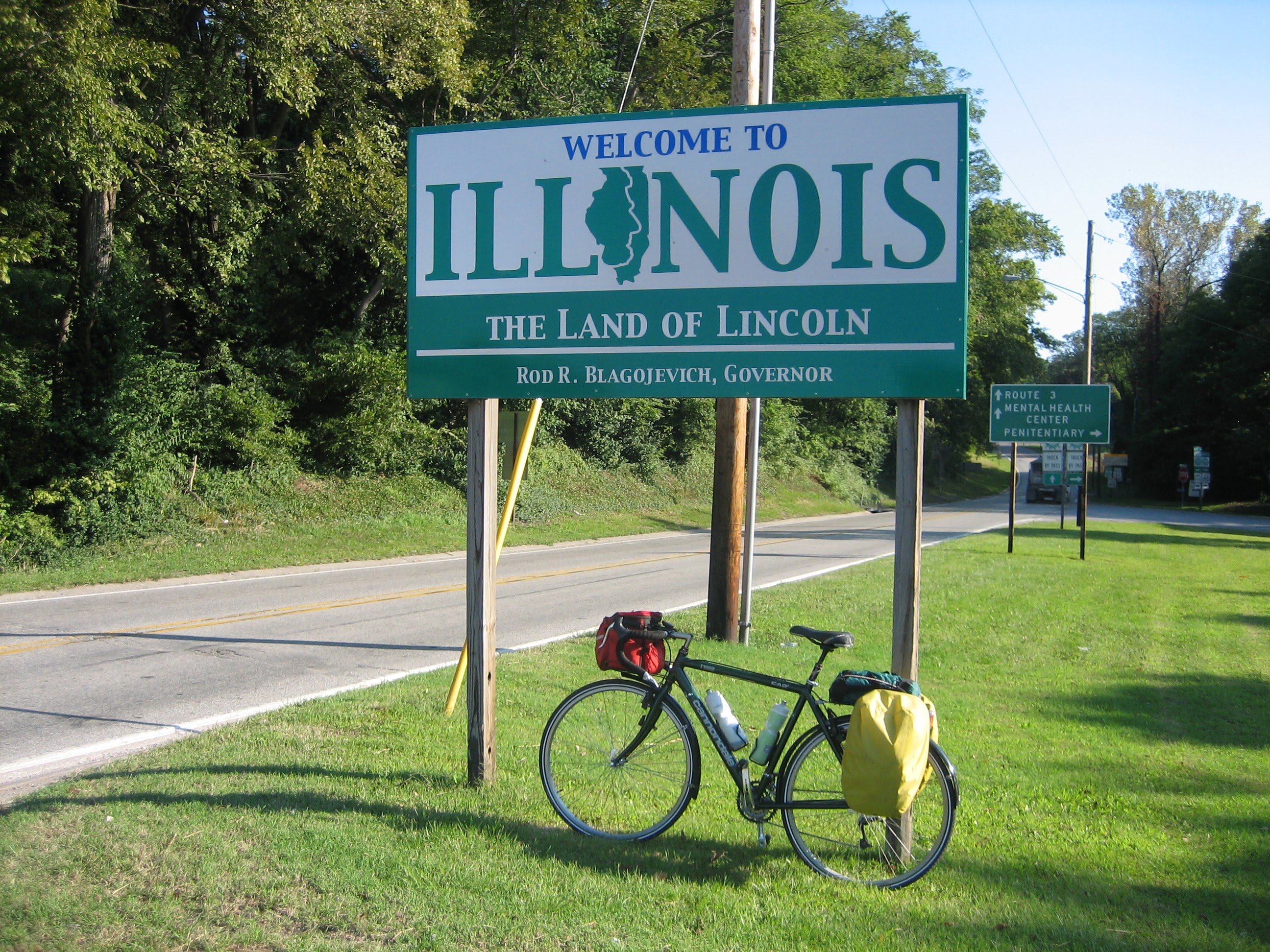 Tom or his touring bicycle photographed at the Illinois state line or state landmark.
