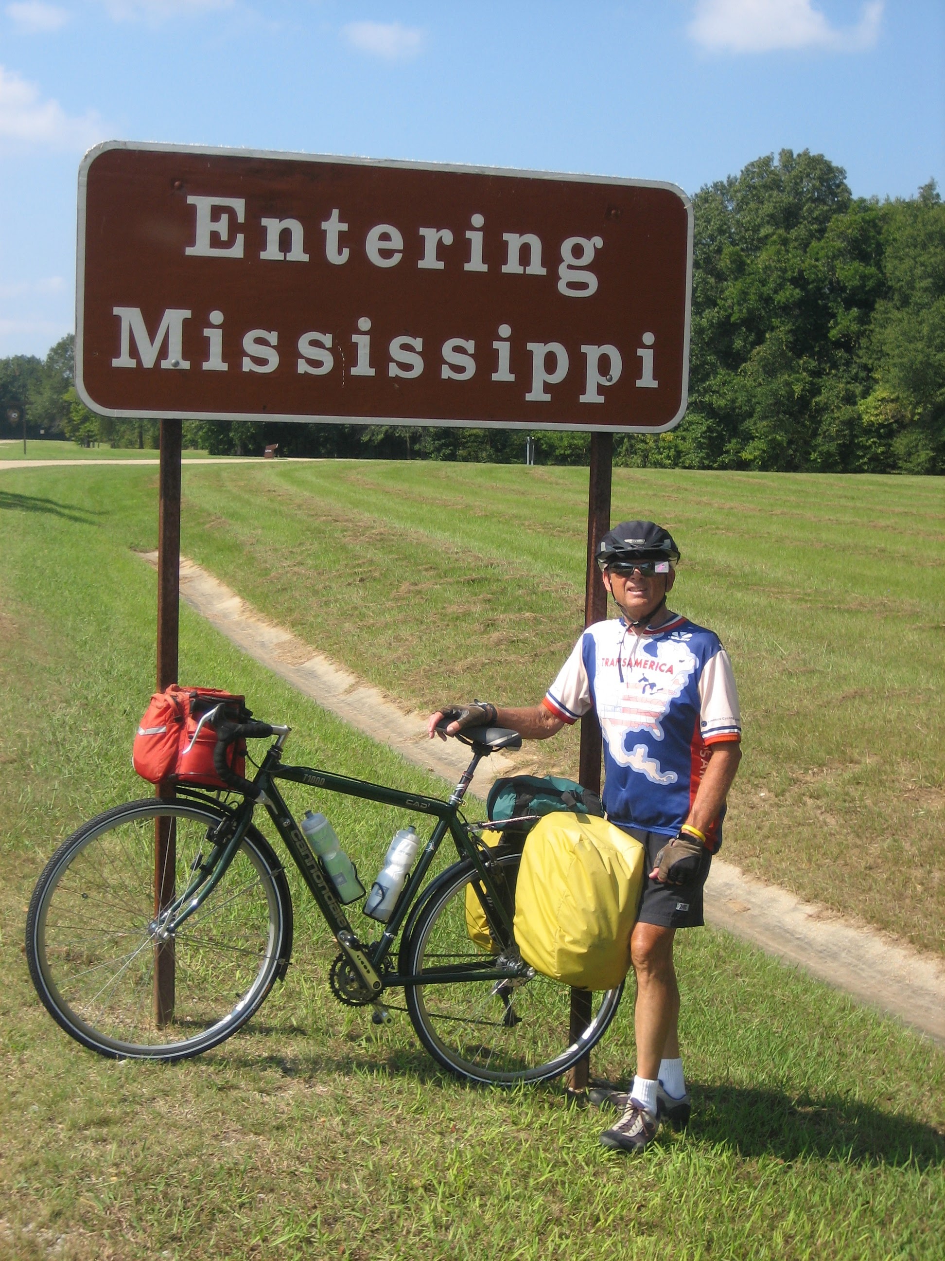 Tom or his touring bicycle photographed at the Mississippi state line or state landmark.