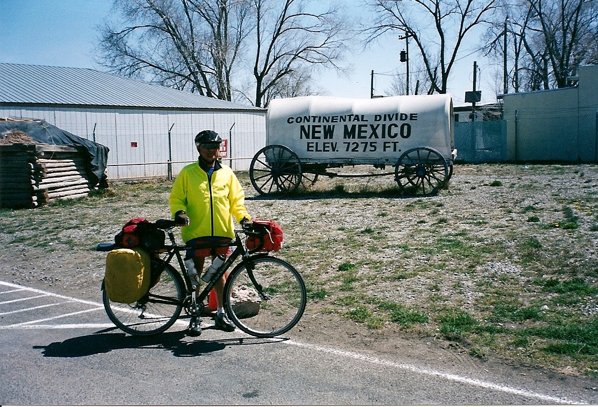 Tom or his touring bicycle photographed at the New Mexico state line or state landmark.