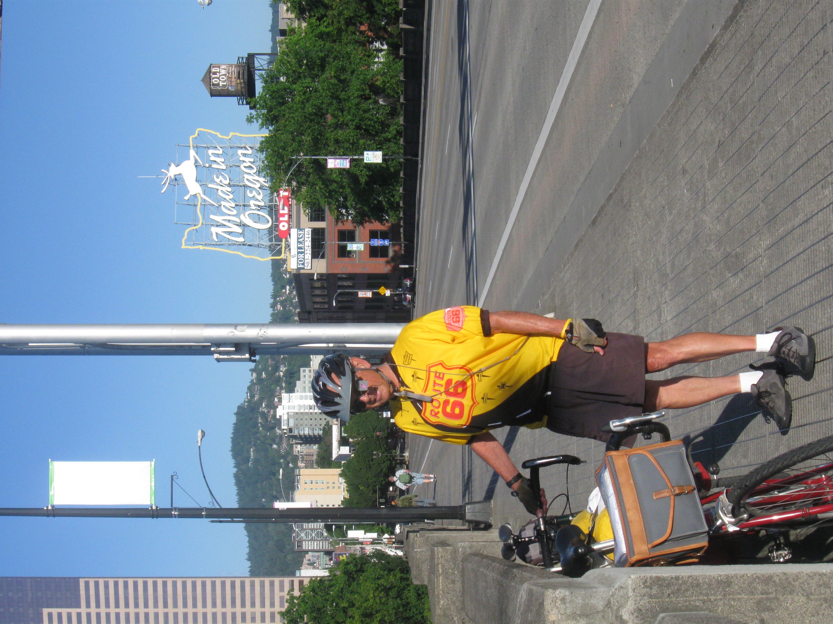 Tom or his touring bicycle photographed at the Oregon state line or state landmark.