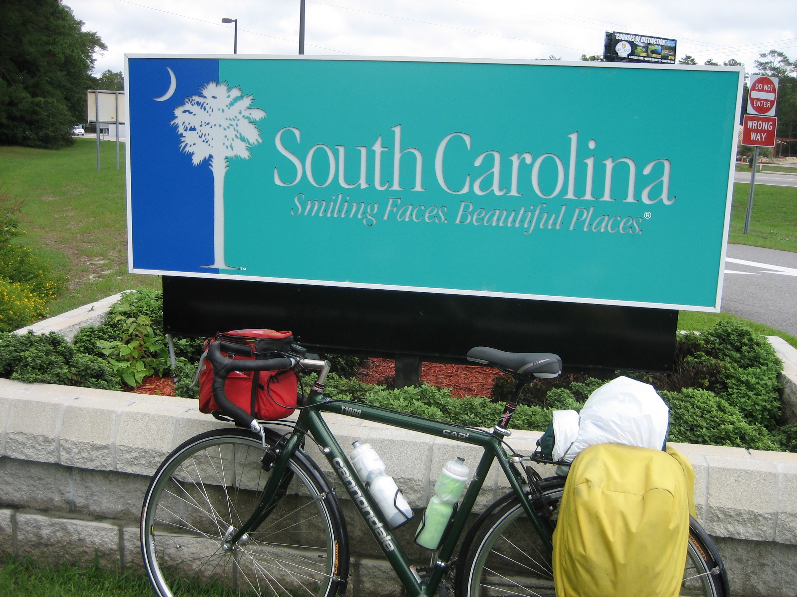 Tom or his touring bicycle photographed at the South Carolina state line or state landmark.