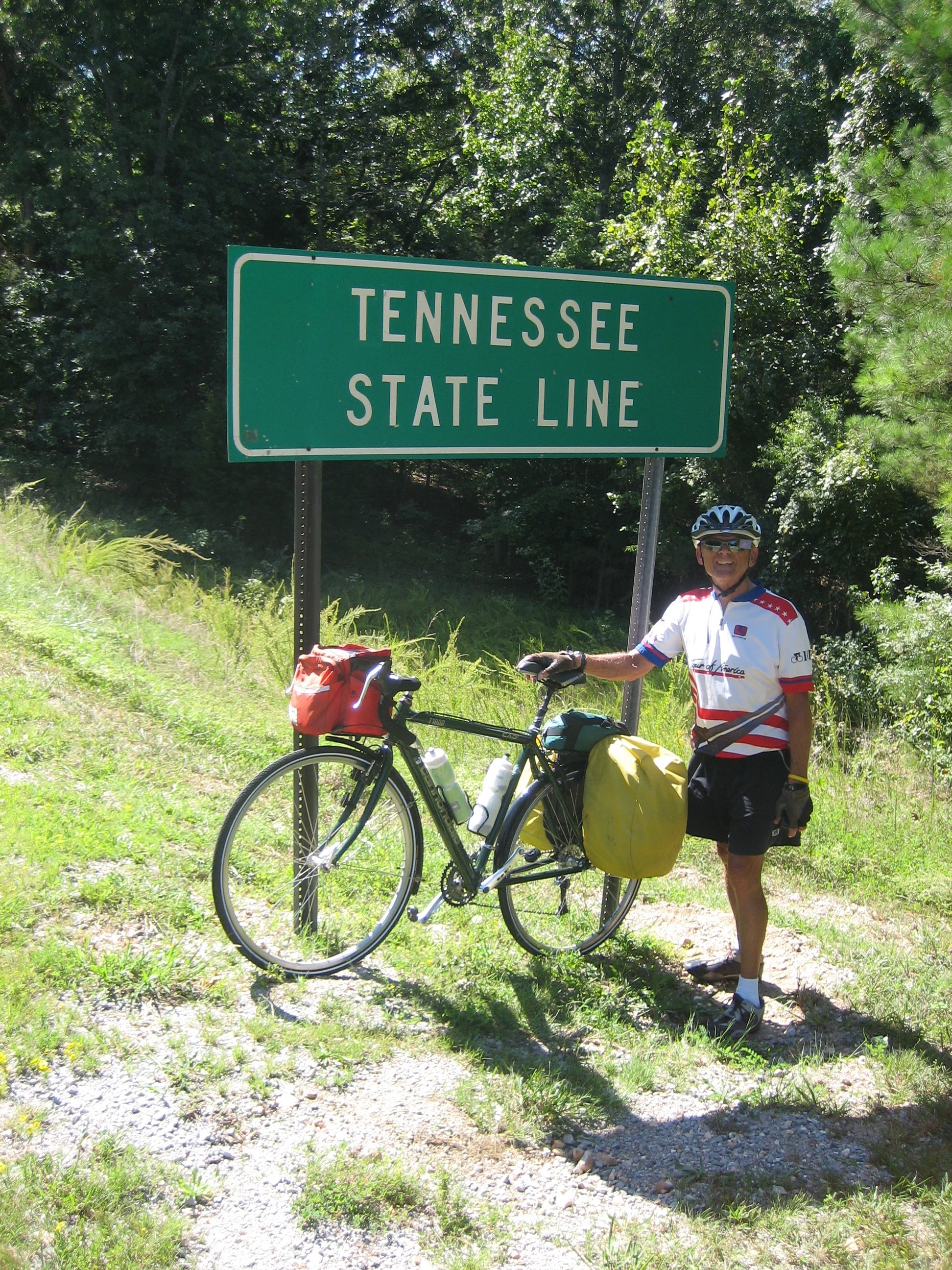 Tom or his touring bicycle photographed at the Tennessee state line or state landmark.