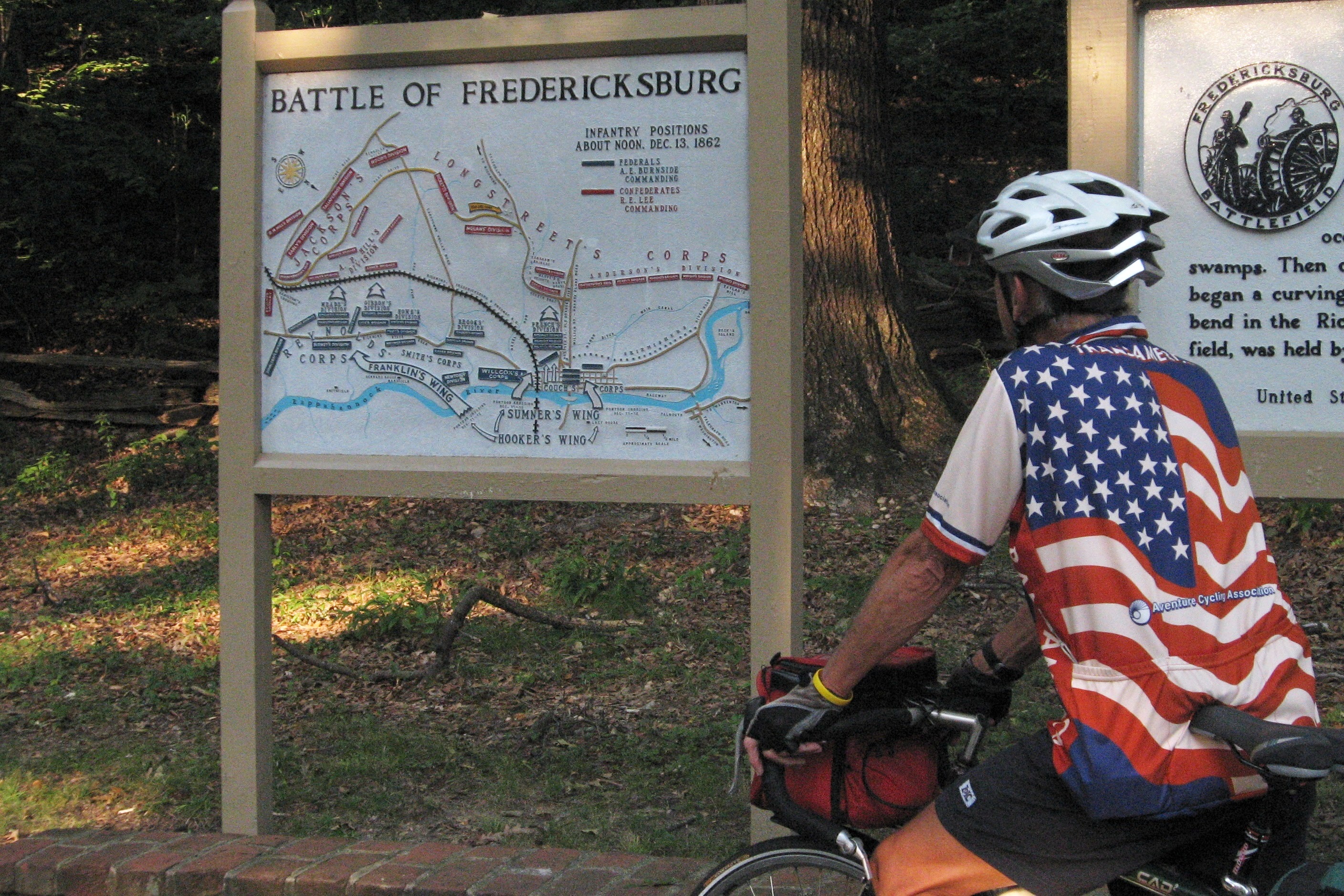 Tom or his touring bicycle photographed at the Virginia state line or state landmark.